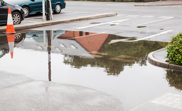 flooded California shopping center parking lot water puddle pooling