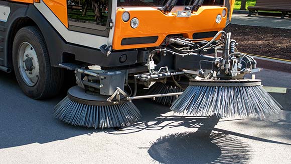 sweeper truck picking up trash with parking lots daily cleaning