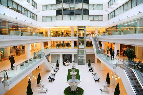 People walking around in large indoor mall serviced by CAM property services