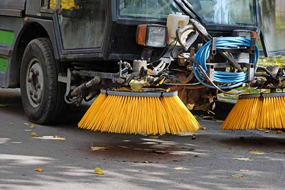 Street sweeper cleaning gutters