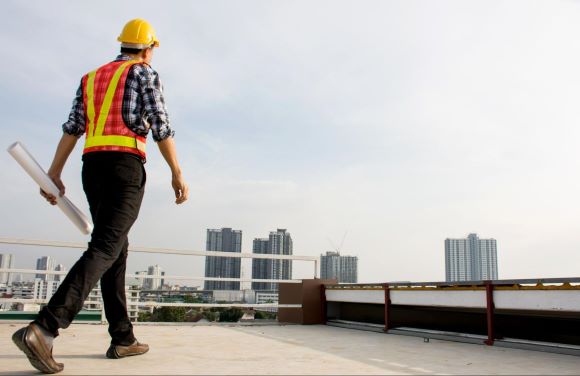 Construction Technician Looking Out Over Tall Building