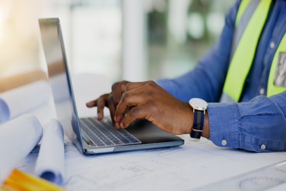 Property Maintenance Expert Working on Laptop