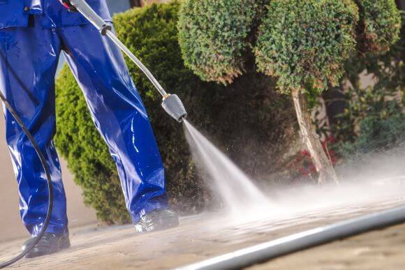 Professional Cleaner Wiping Down Glass